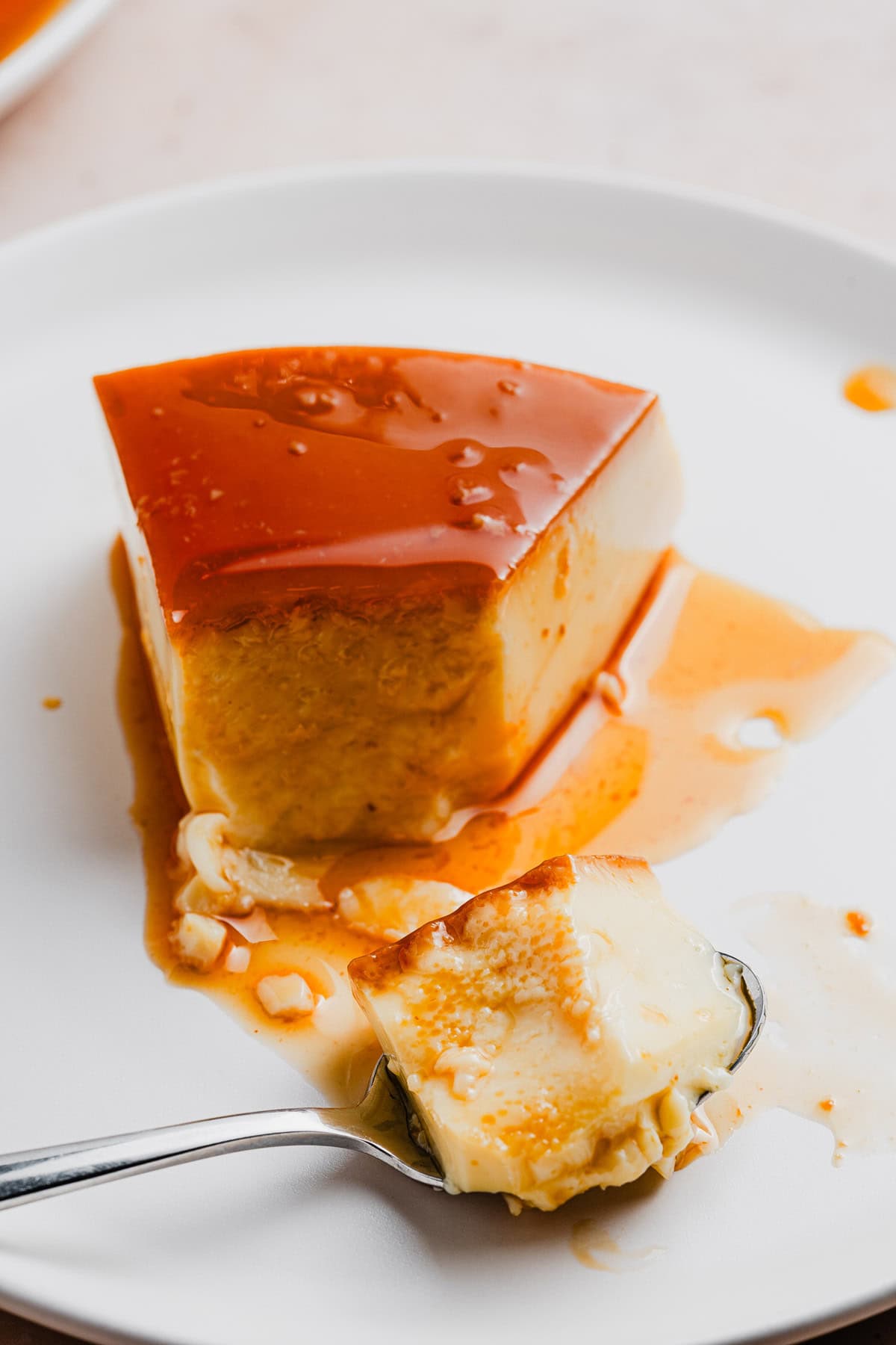 A slice of Brazilian flan on a plate.