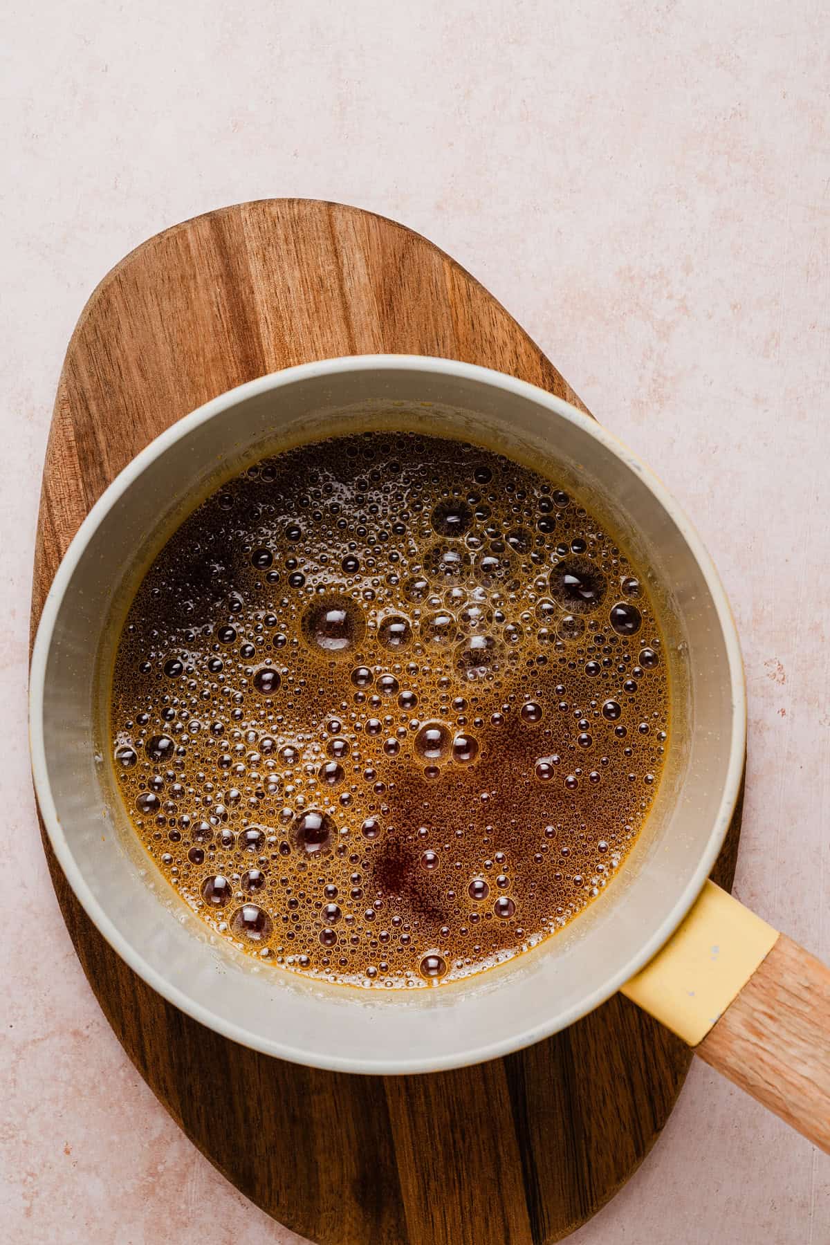 Making caramel layer in a saucepan.