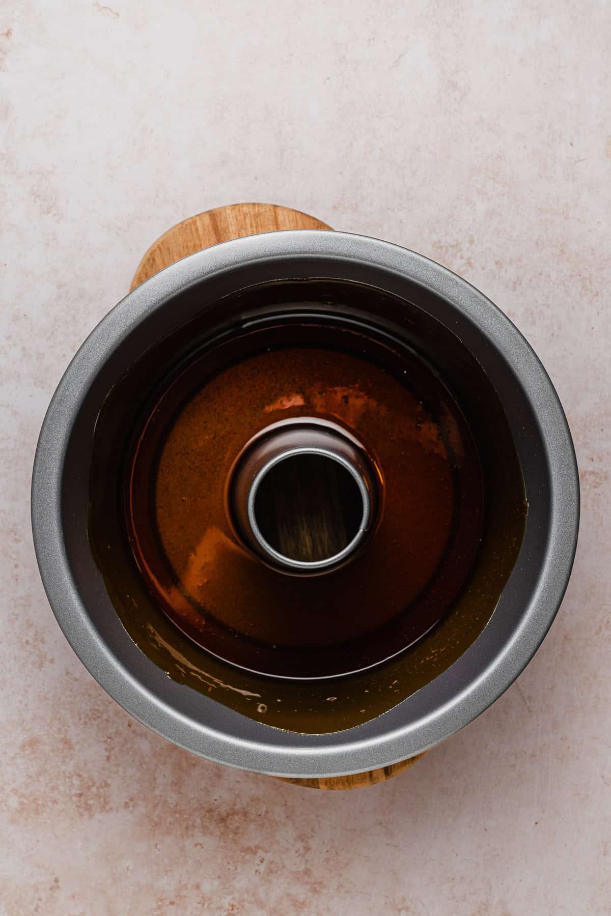 Caramel poured in a tube pan.