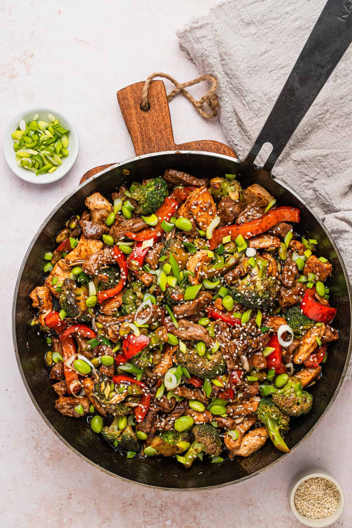 The completed chicken and steak stir fry recipe in the skillet.