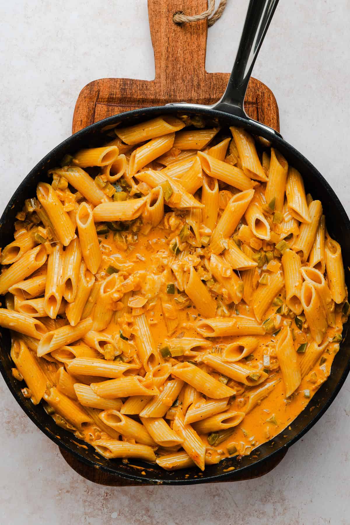 Mixing the pasta into the sauce.