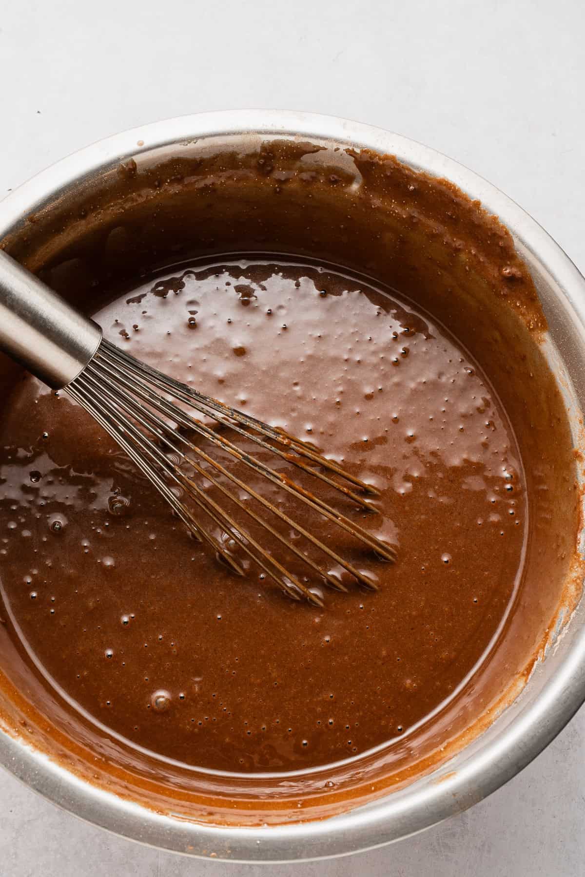 Adding wet ingredients to dry ingredients.