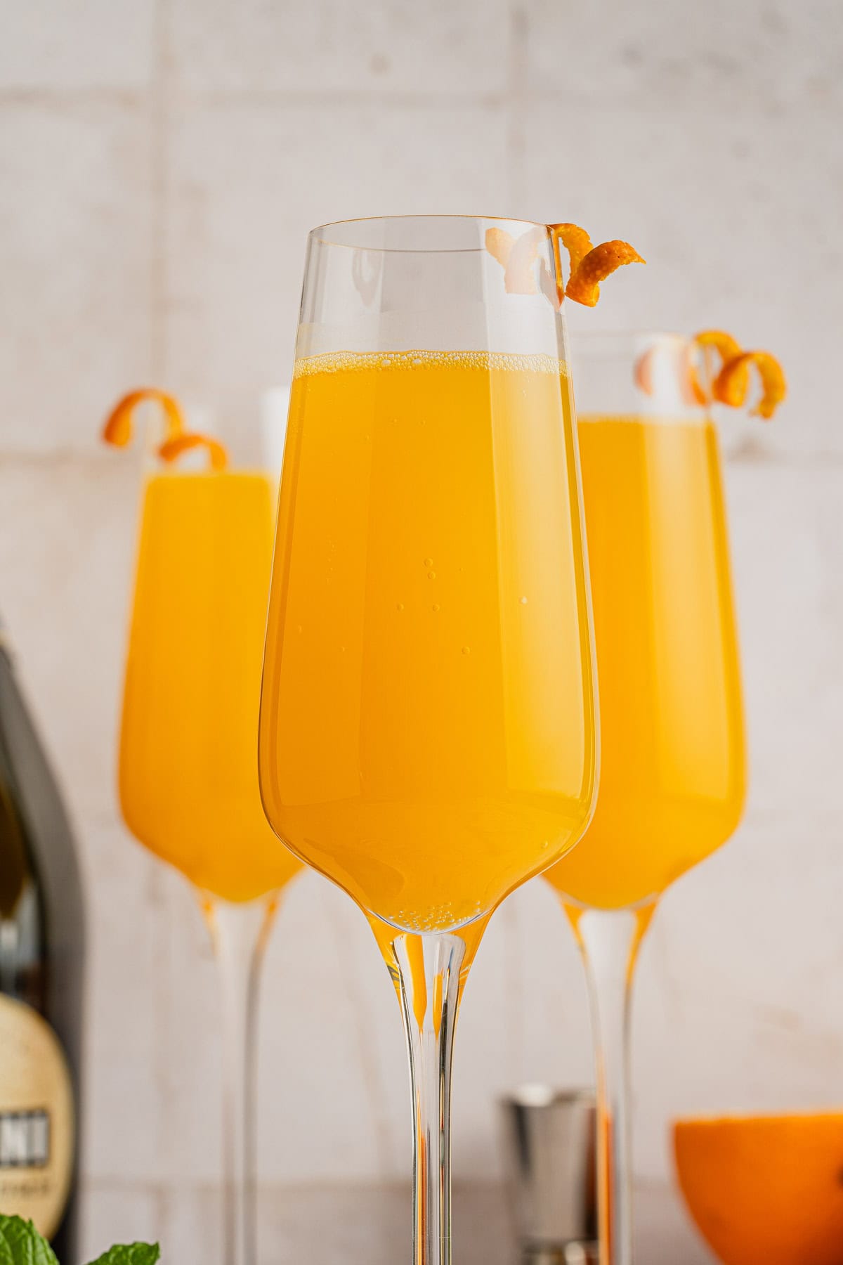 Prosecco Mimosa with curled orange zest curls.