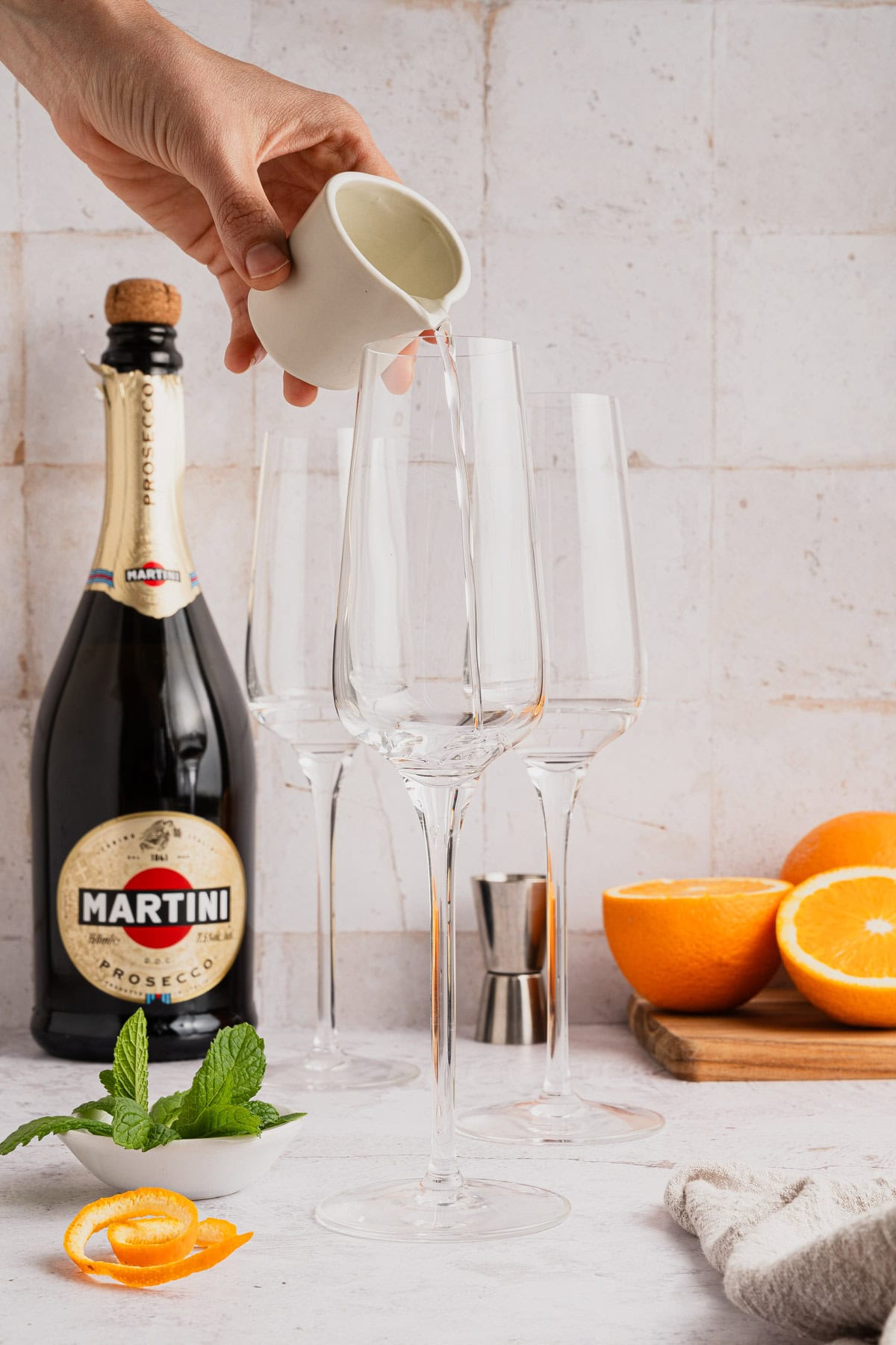 Adding Cointreau to flutes.