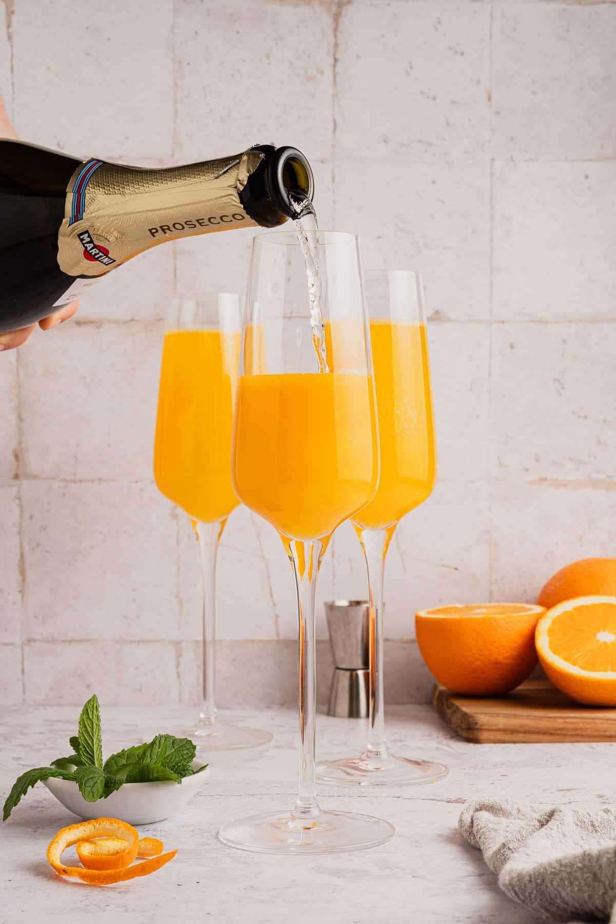 Adding Prosecco to glasses.