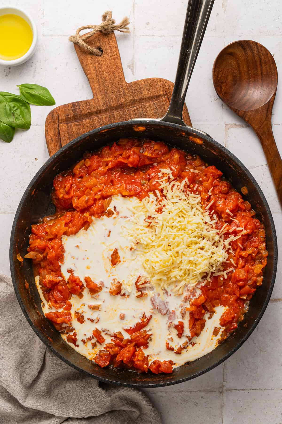 Adding cream to the sauce.