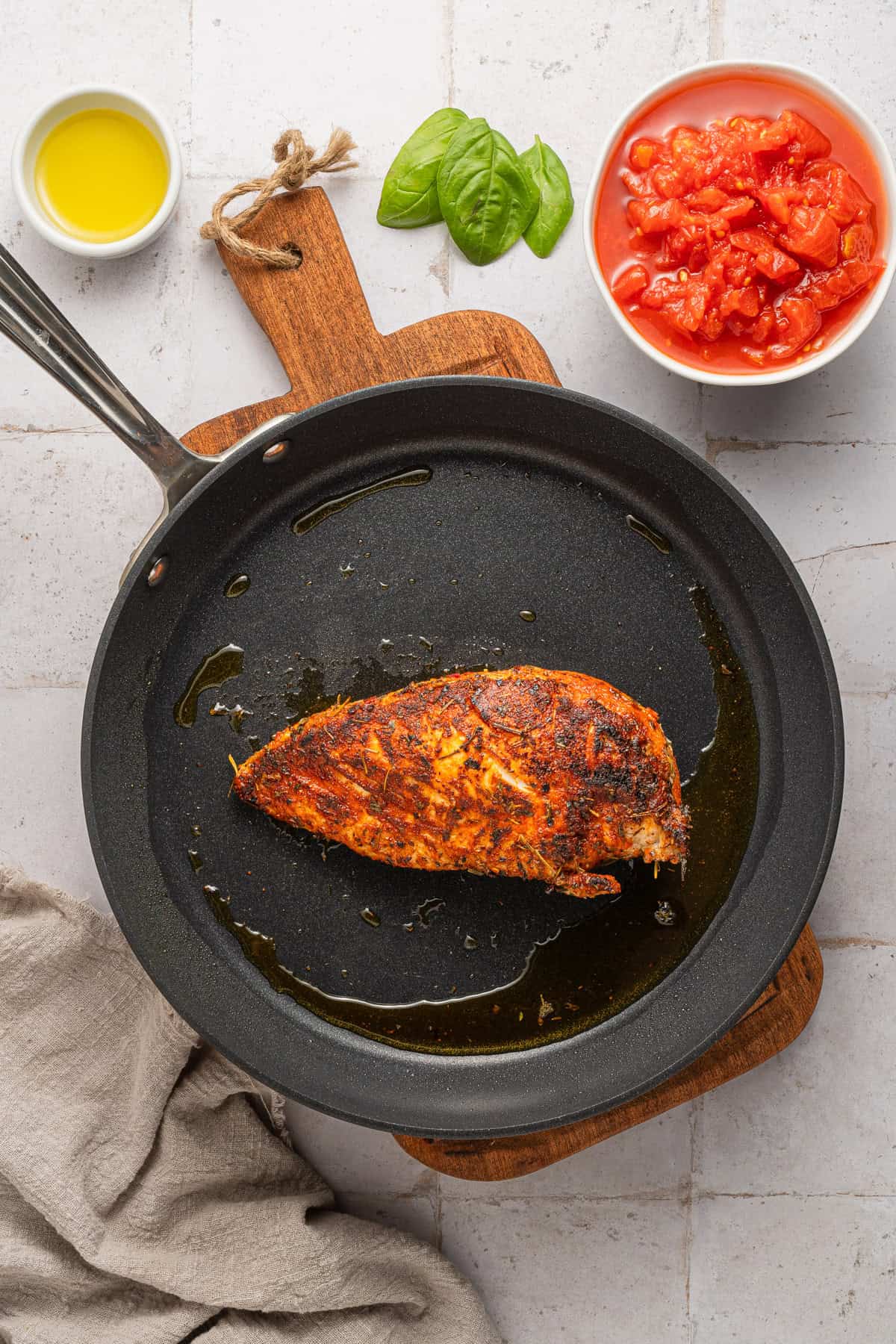 Searing chicken in a skillet.