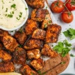 Cajun salmon bites on a platter with a bowl of lemon garlic aioli.