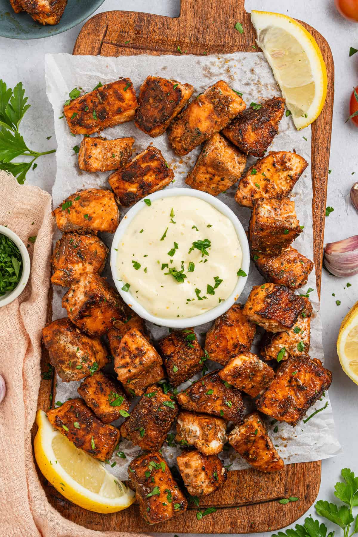 A platter of cajun bites with a bowl of aioli.