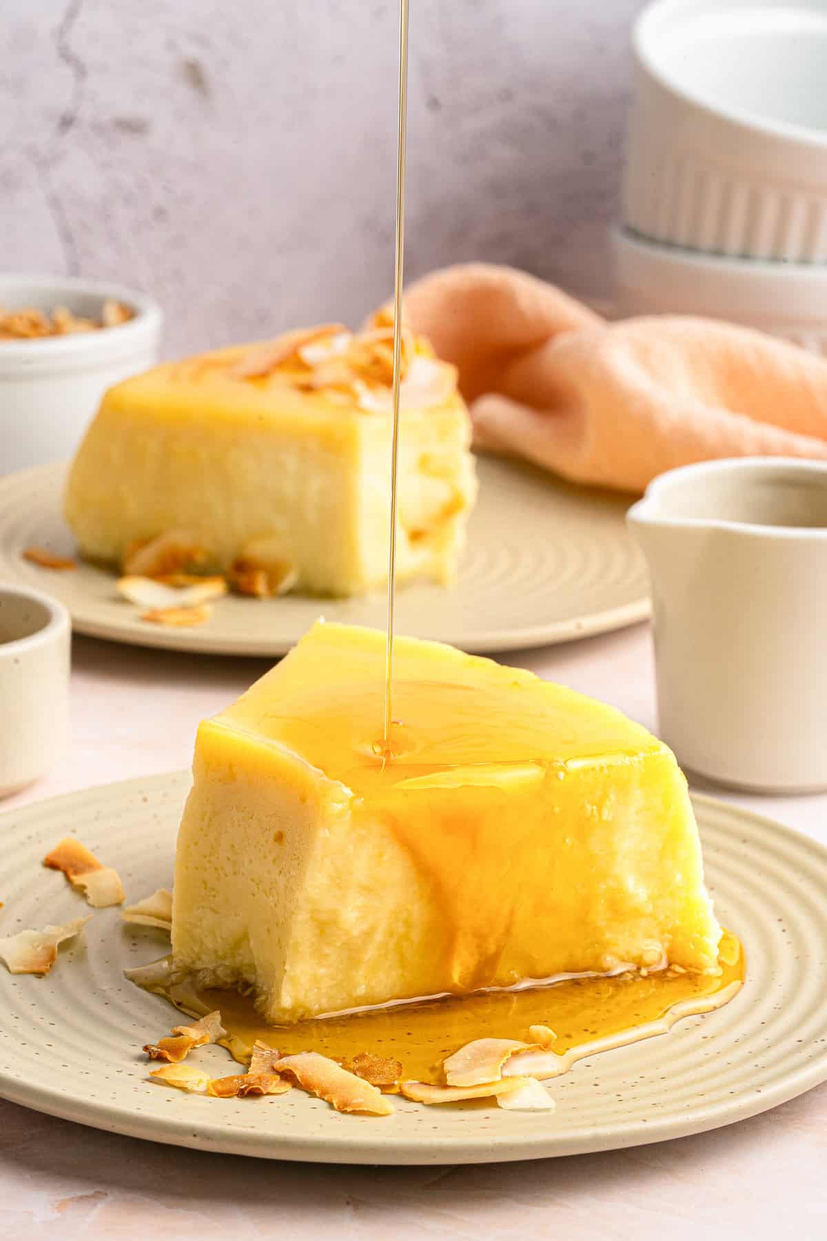Two pieces of coconut flan with caramel sauce poured over.