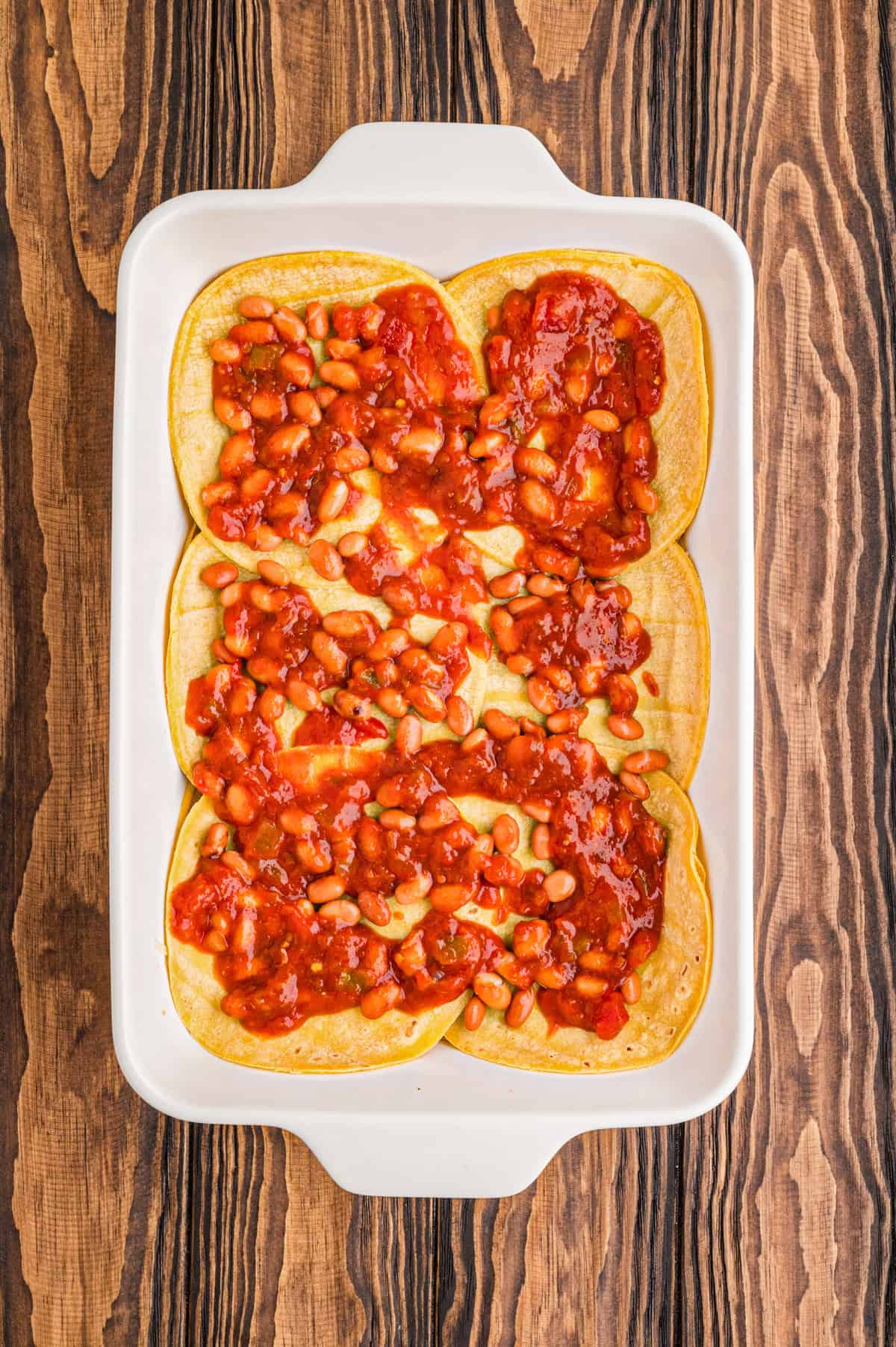 Red salsa layered in baking dish.