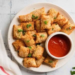 Totinos pizza rolls made in the air fryer on a plate.