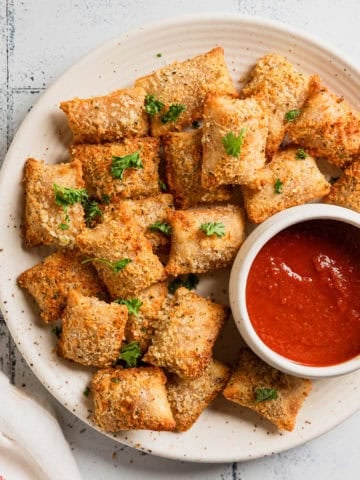 Totinos pizza rolls made in the air fryer on a plate.