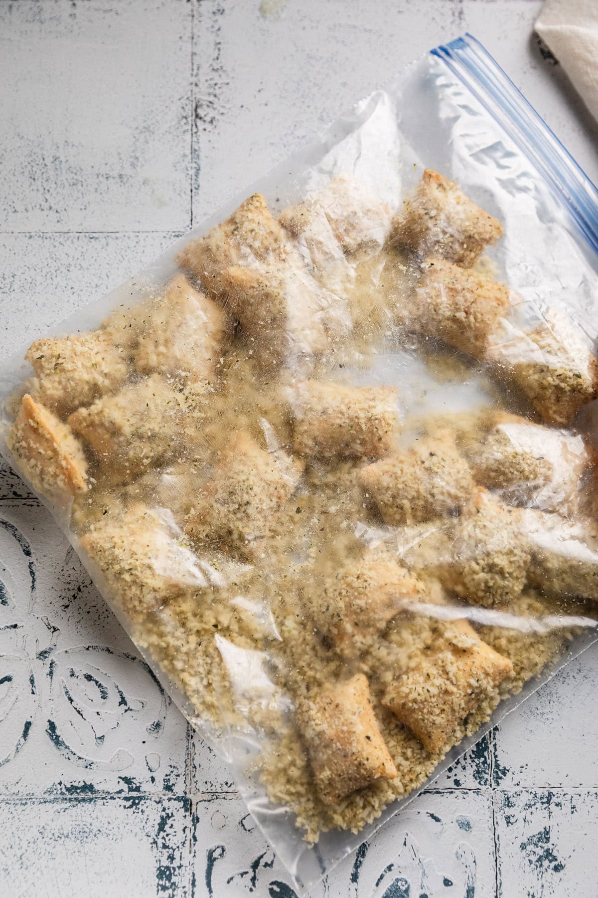 A ziplock bag with panko coated pizza rolls.
