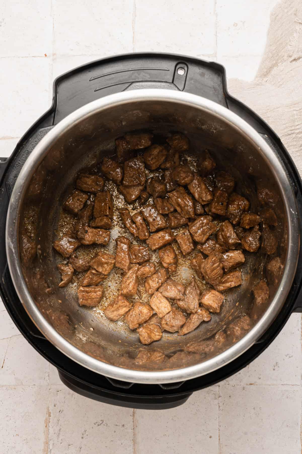 Browning the pork pieces in the instant pot.