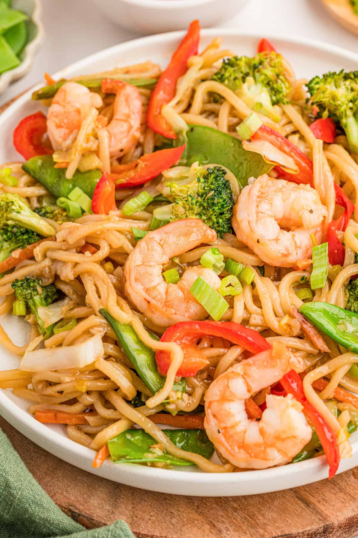 Shrimp stir fry with noodles on a plate.
