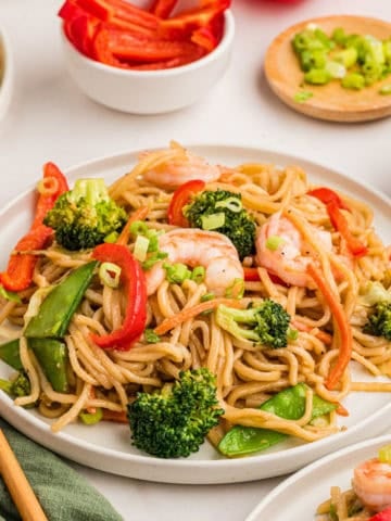 Shrimp stir fry recipe with lo mein noodles on a plate.