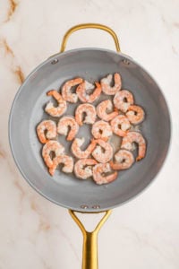 Cooked shrimp in skillet.