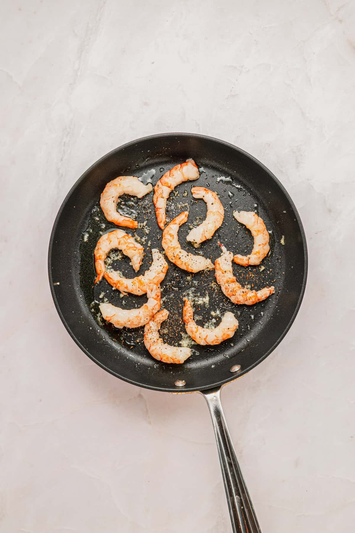 Cooking shrimp in skillet.