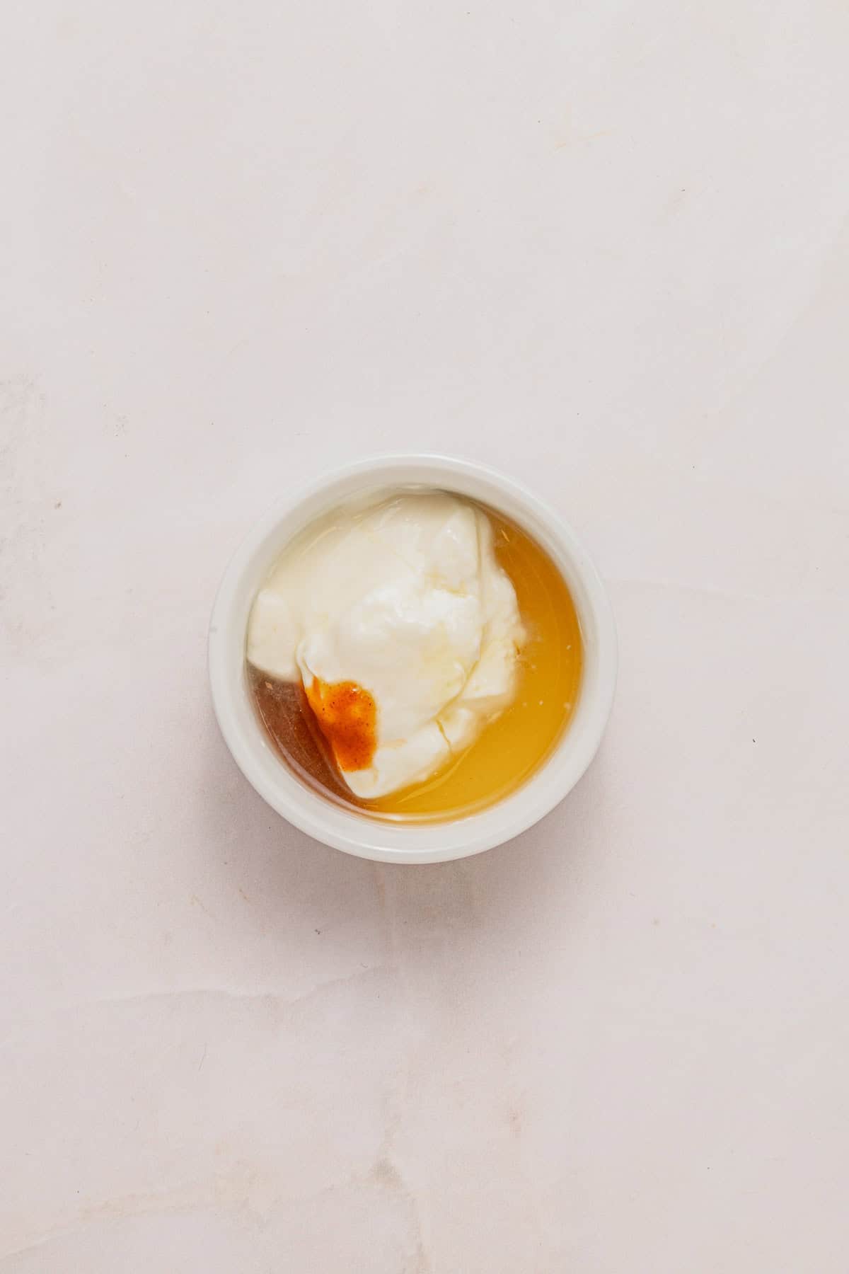 Spicy mayo in a white dish.