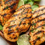 Cilantro lime green chile grilled chicken on a cutting board.