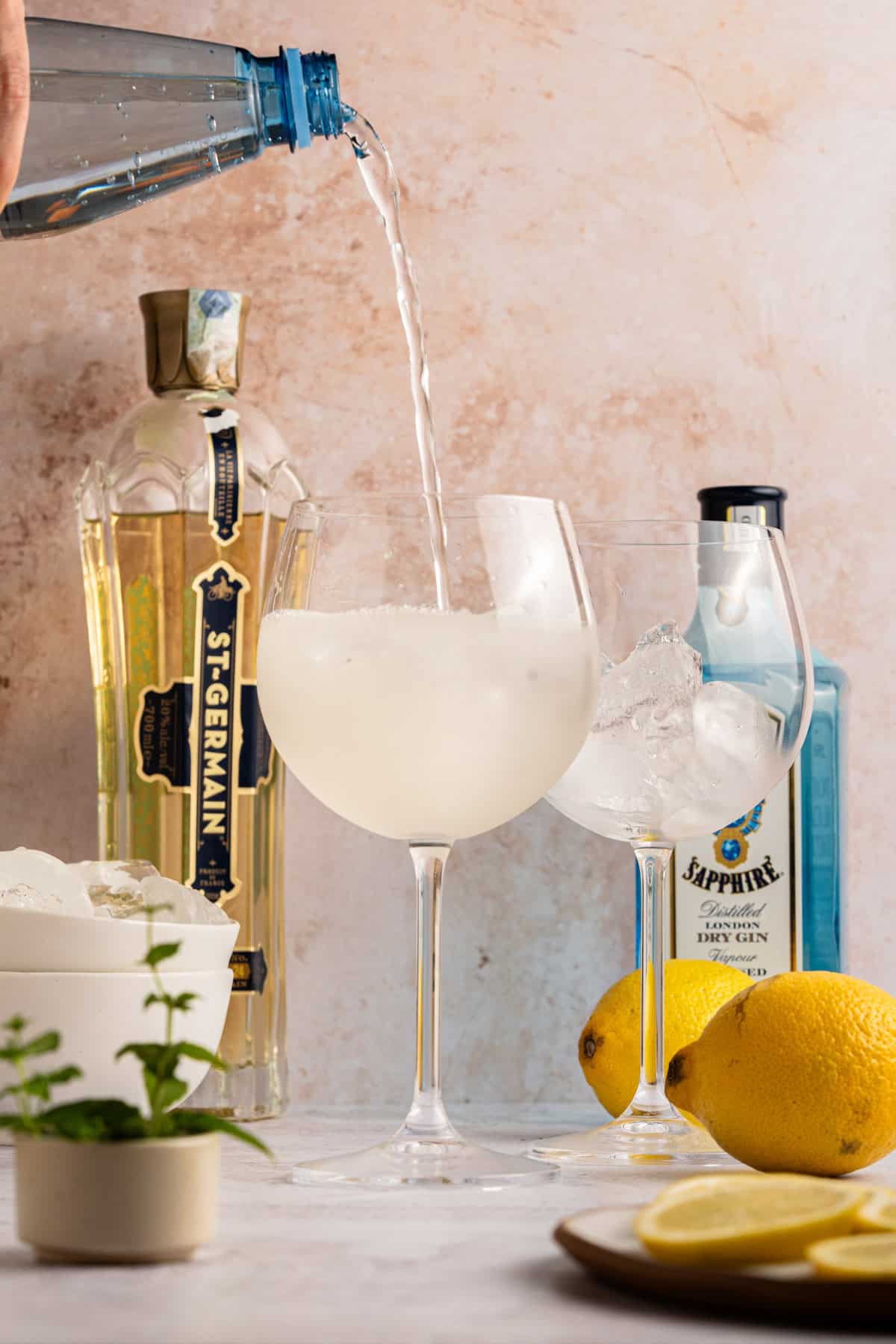 Topping off glasses with club soda.